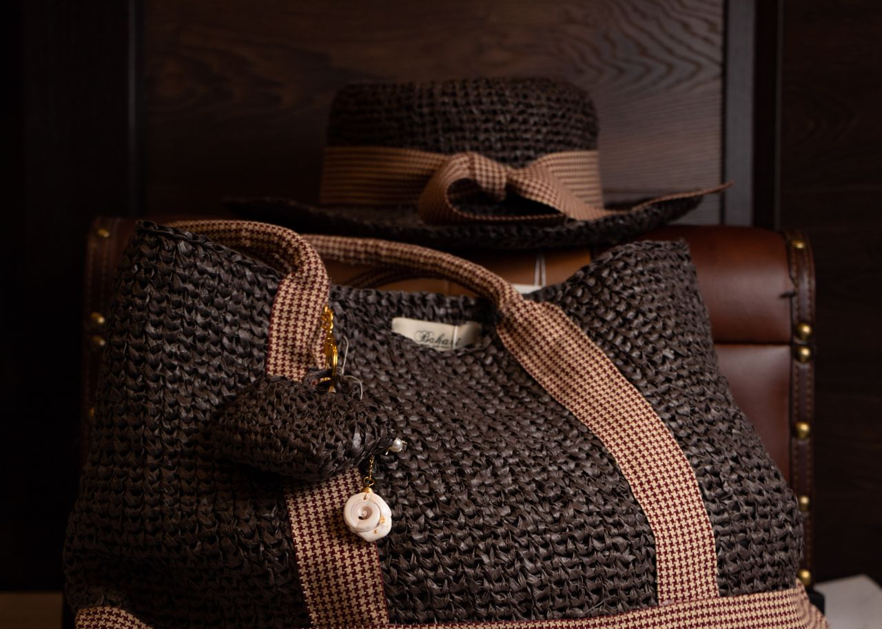 team-03 Stylish brown woven bag with matching hat, perfect for fashion-forward accessories.