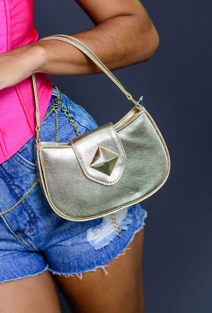 services-01 Fashionable woman in pink top and denim shorts holding a chic gold purse. Perfect for style and fashion themes.