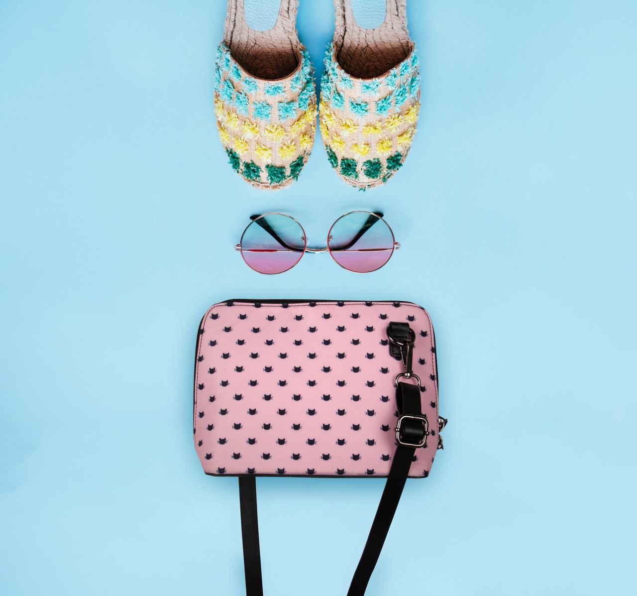 services-01 Trendy flat lay of colorful footwear, stylish bag, and sunglasses on a blue background.